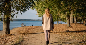 Woman walking outdoors on a spring morning while rebuilding healthy habits and restoring energy after winter.